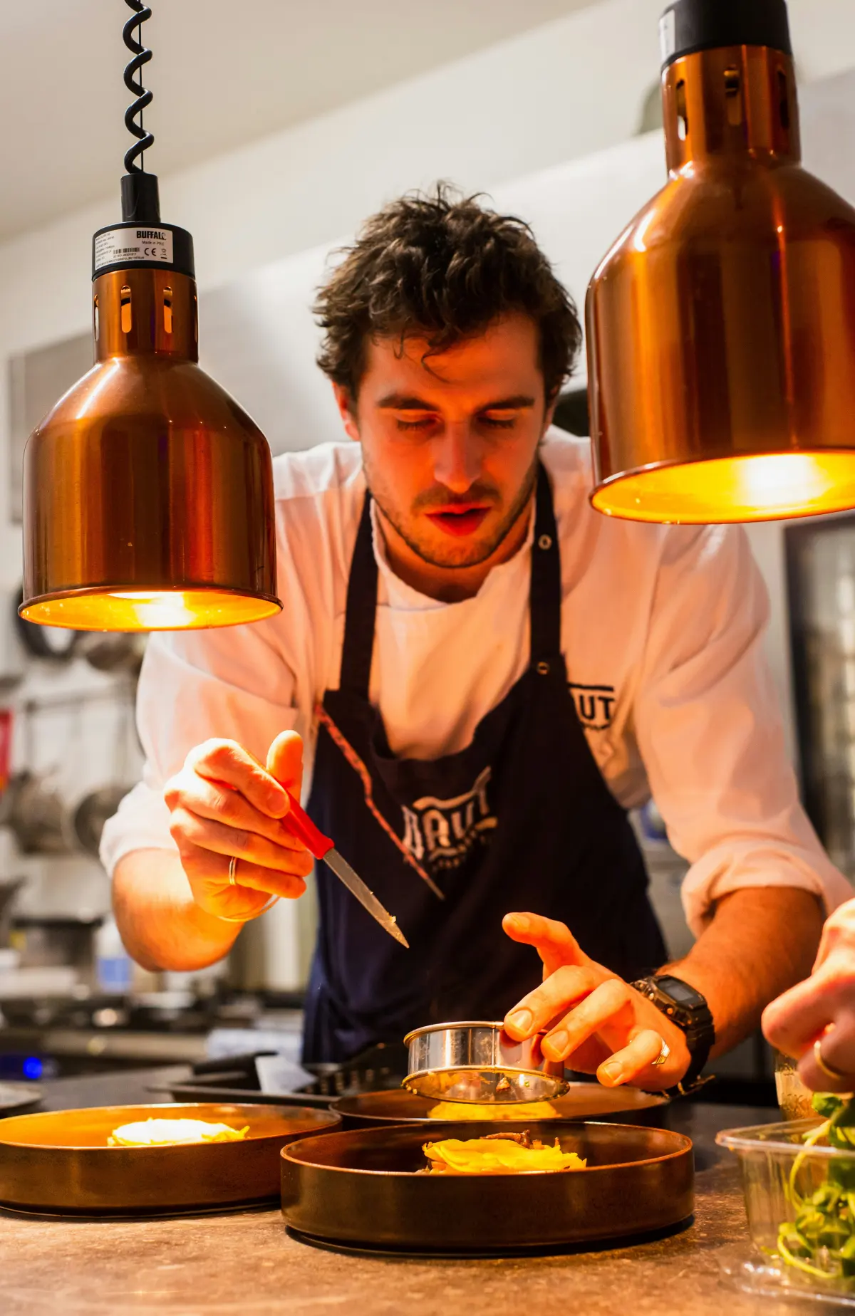 A home chef plating a freshly made dish