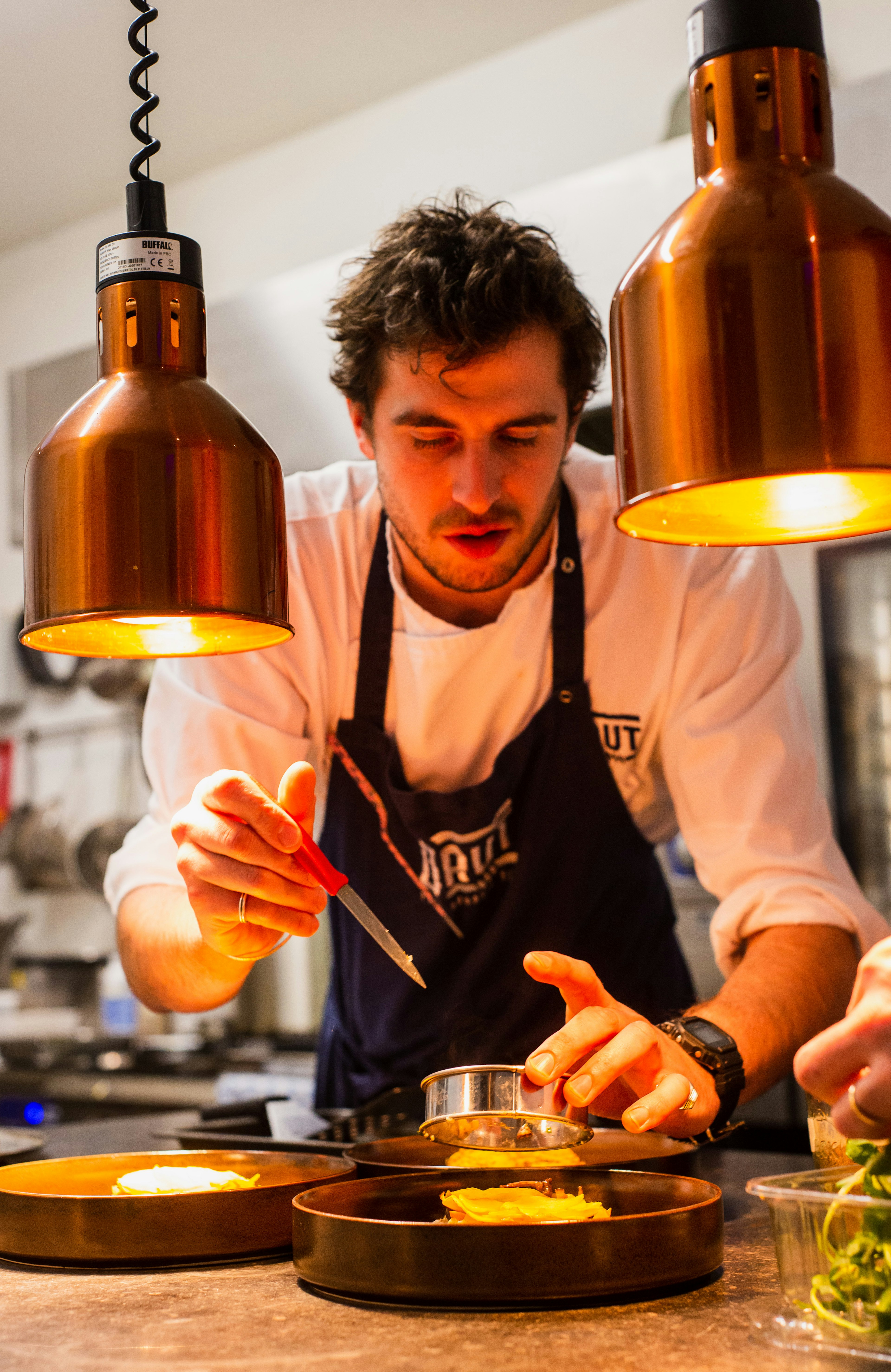 A home chef finishing a freshly cooked dish